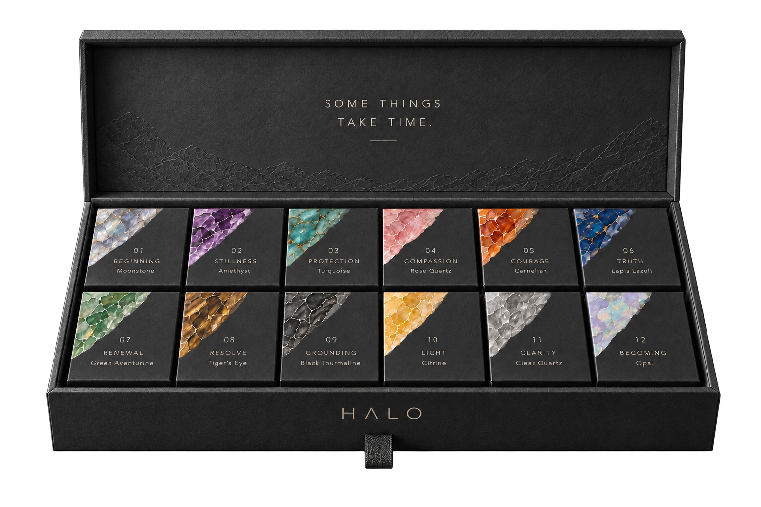 Charcoal Halo Year One presentation case with twelve numbered mineral-decorated boxes.