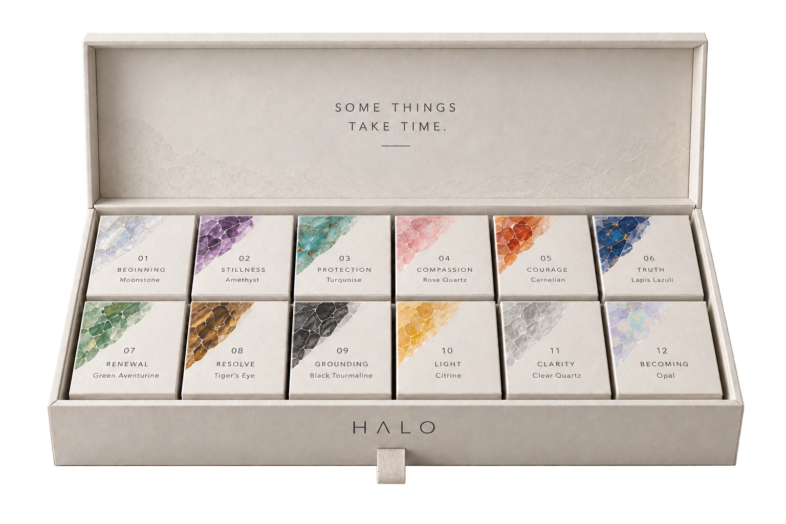 Ivory Halo Year One presentation case with twelve numbered mineral-decorated boxes.